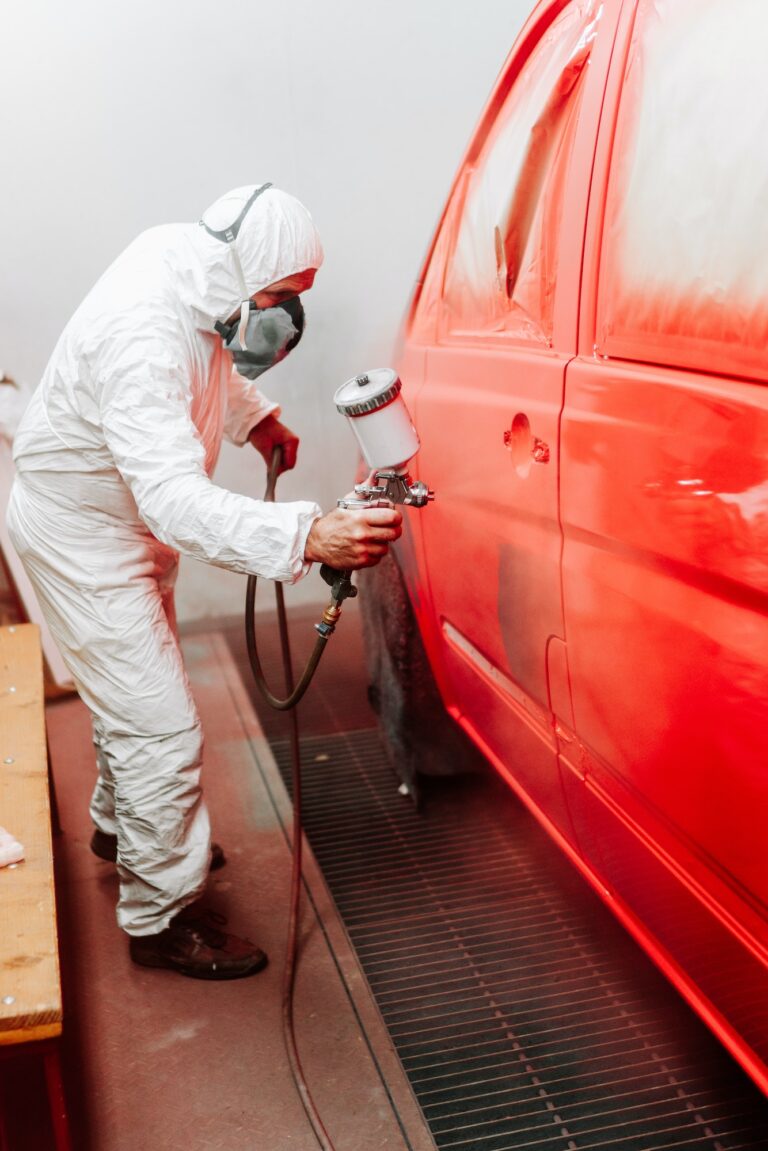 mechanic engineer painter painting a car using a car sprayer, airbrush compressor